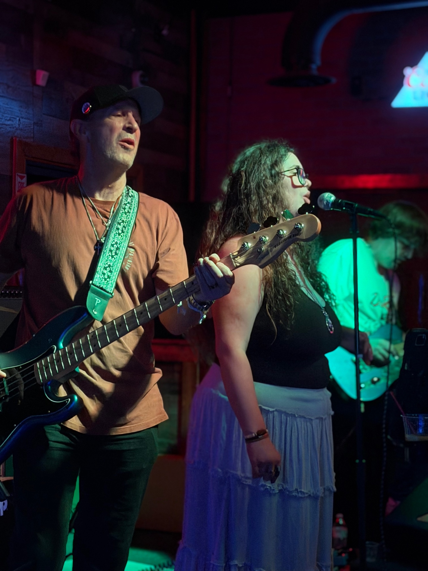Mike Davidson on bass singing alongside Emma at a Ten Mile Bay show