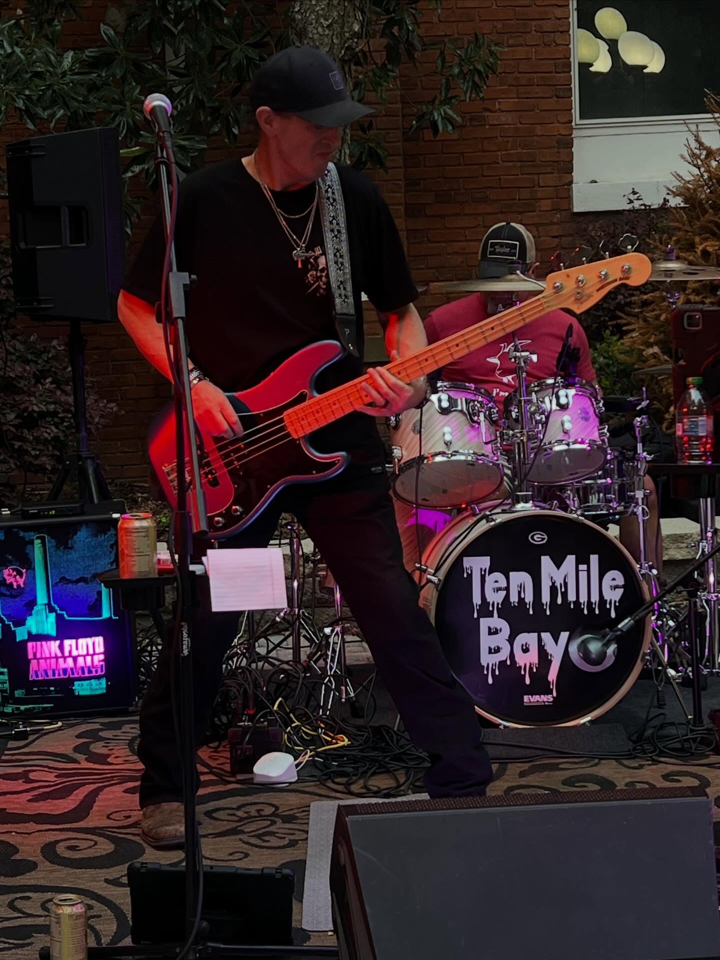 Mike Davidson playing red bass at an outdoor Ten Mile Bay show