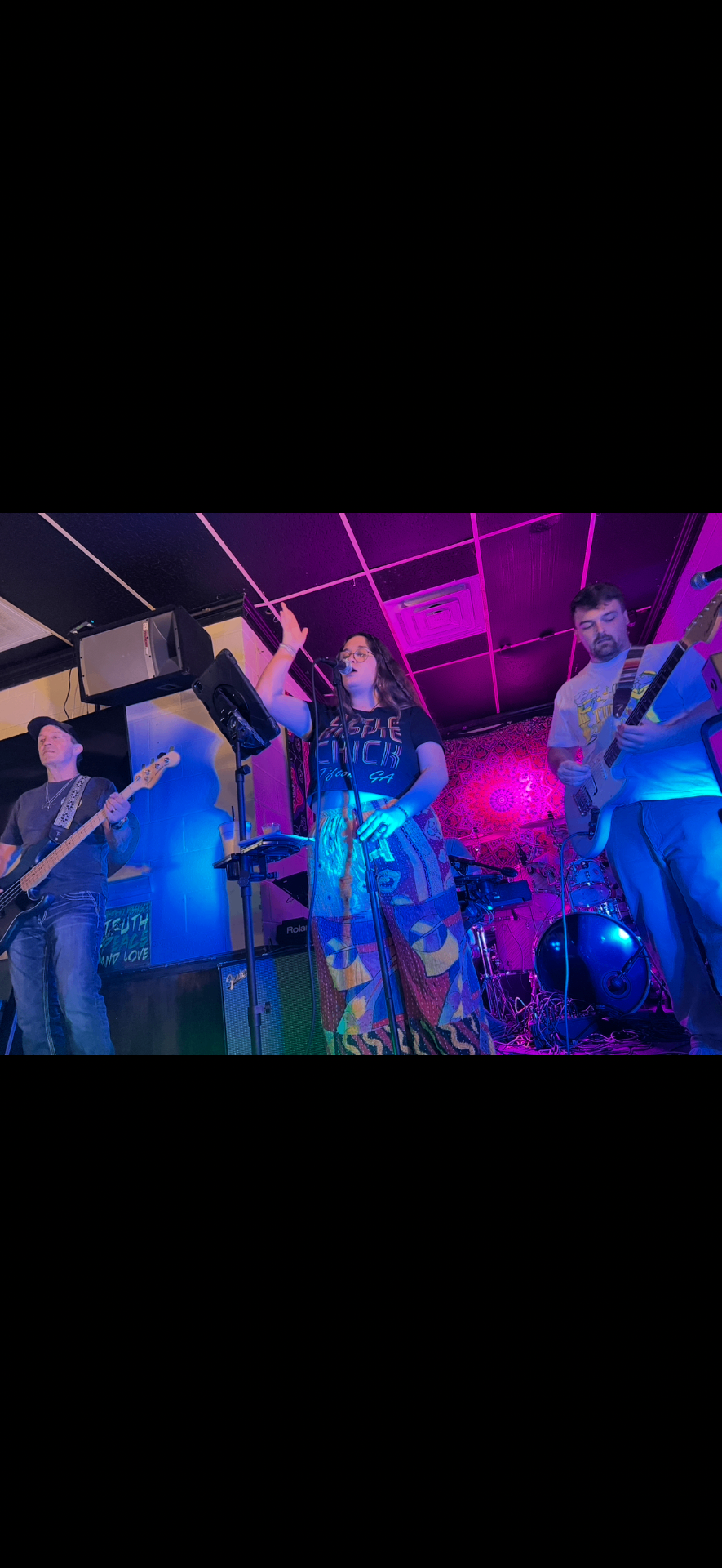 Ten Mile Bay performing under deep purple stage lights